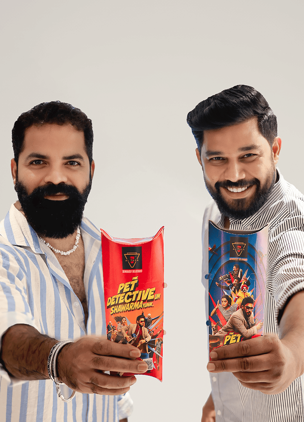 pet detective team holding Al Taza shawarma wraps during their movie promotion